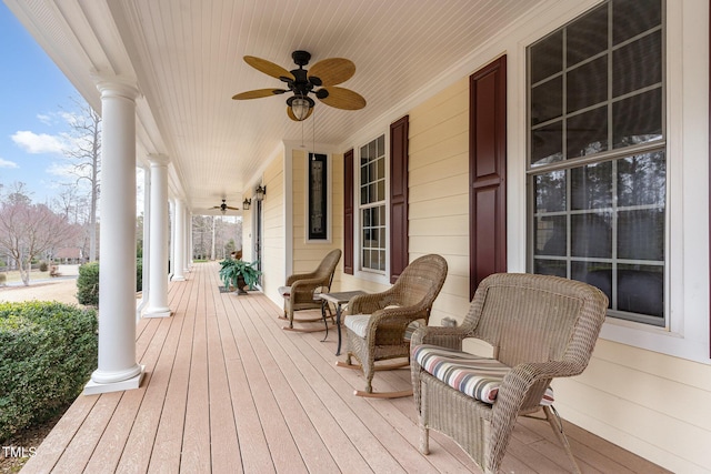 wooden deck featuring covered porch and ceiling fan