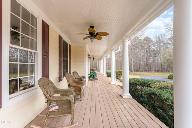 deck featuring covered porch and ceiling fan