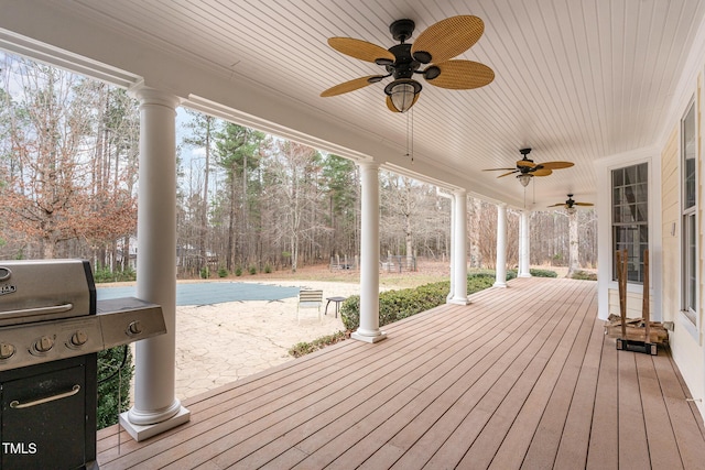 wooden deck with a ceiling fan