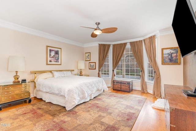 bedroom with a ceiling fan, wood finished floors, baseboards, and ornamental molding