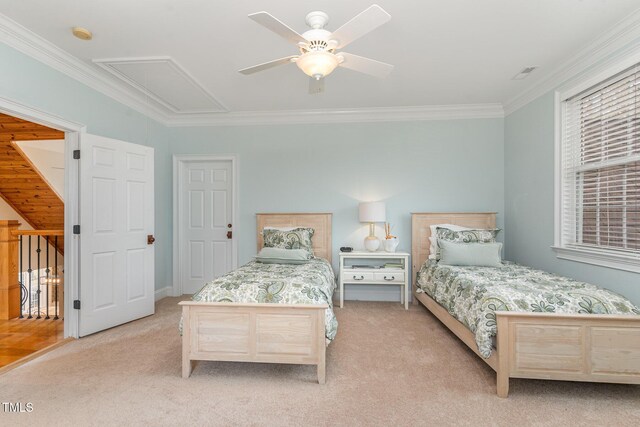 bedroom featuring visible vents, crown molding, ceiling fan, light colored carpet, and attic access