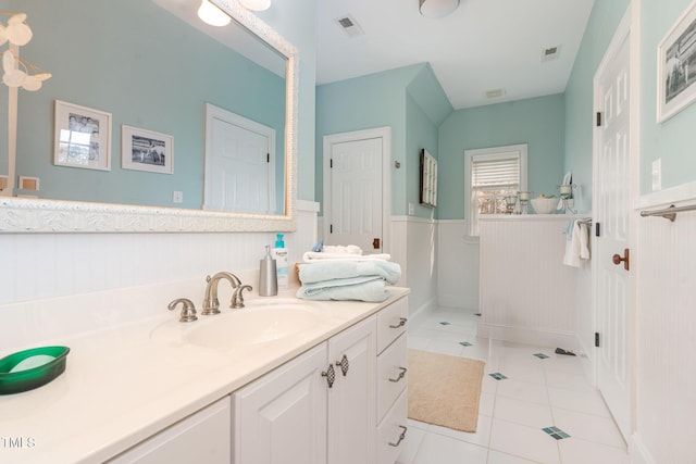 bathroom with tile patterned flooring, a wainscoted wall, vanity, and visible vents