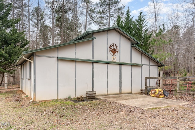 view of pole building featuring fence