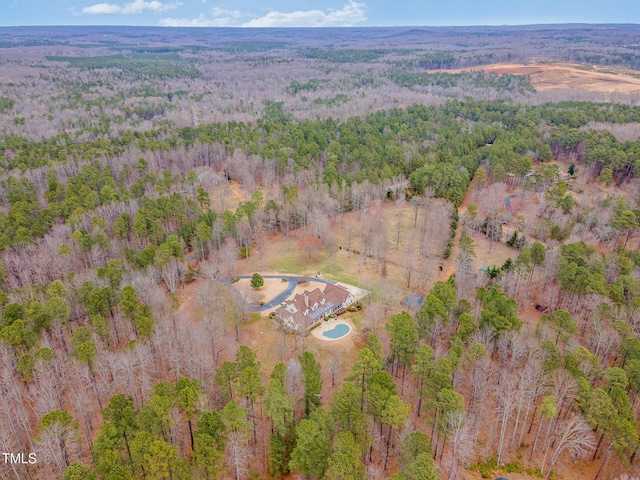 drone / aerial view featuring a wooded view