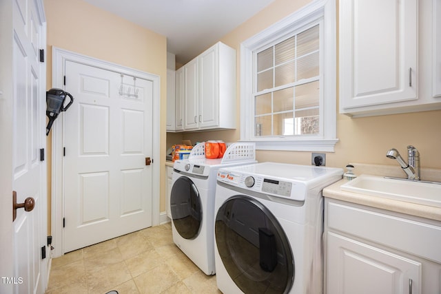 washroom with a sink, cabinet space, separate washer and dryer, and light tile patterned floors