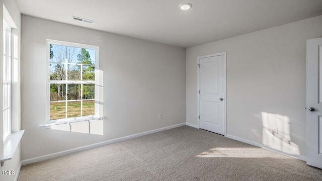 unfurnished bedroom with visible vents, baseboards, and carpet