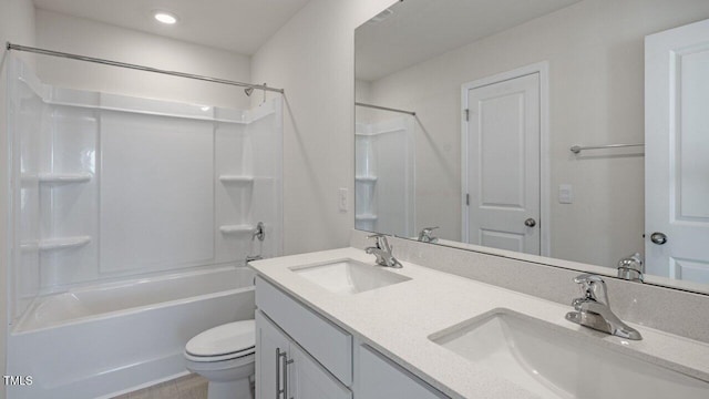 full bathroom with a sink, shower / bath combination, toilet, and double vanity