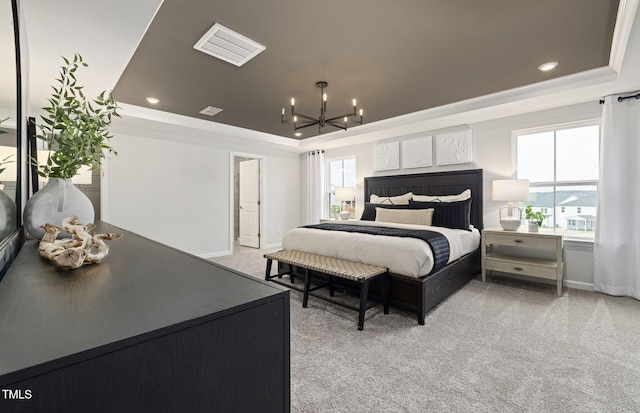 bedroom with visible vents, a raised ceiling, multiple windows, and a chandelier