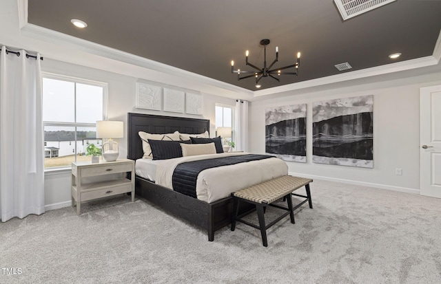 carpeted bedroom featuring a notable chandelier, visible vents, crown molding, and a tray ceiling