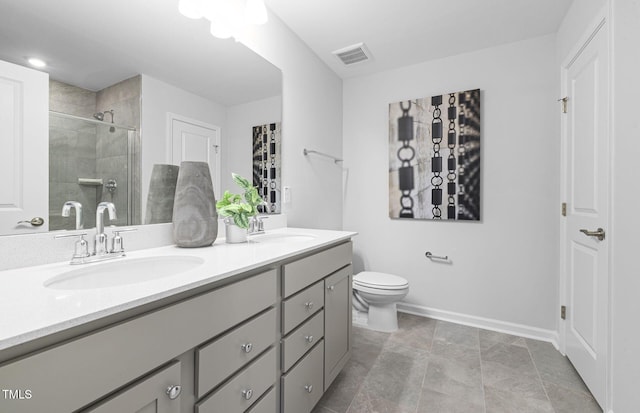 full bath with a sink, toilet, a stall shower, and double vanity