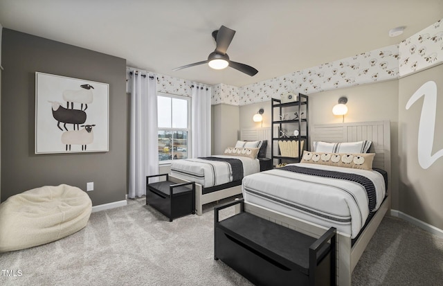 bedroom with wallpapered walls, light colored carpet, baseboards, and ceiling fan