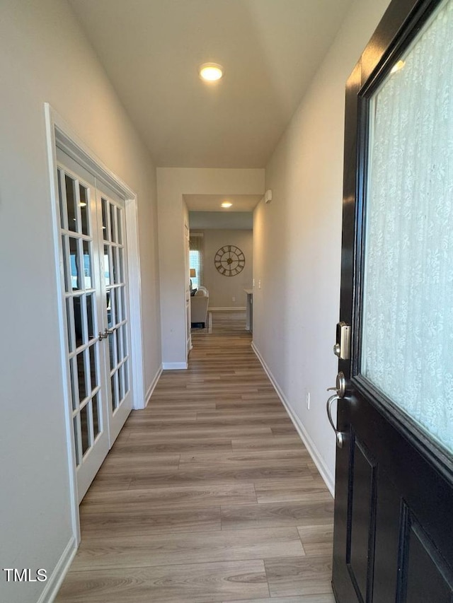 corridor with recessed lighting, light wood-style floors, baseboards, and french doors