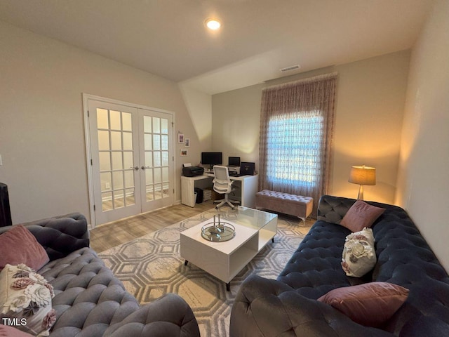 living area featuring recessed lighting, french doors, visible vents, and light wood-style flooring