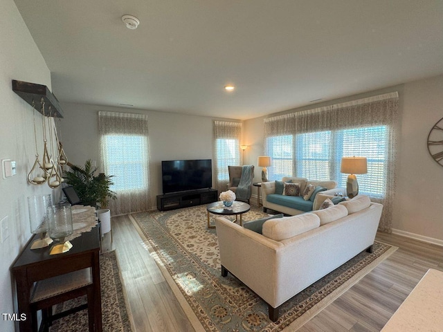 living room with recessed lighting, wood finished floors, and baseboards