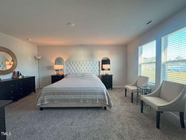 bedroom with visible vents, baseboards, and carpet flooring