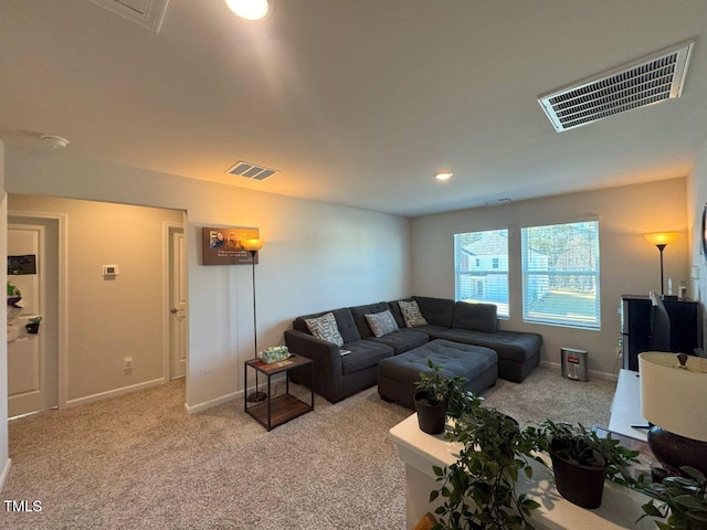 living room with light carpet, visible vents, and baseboards