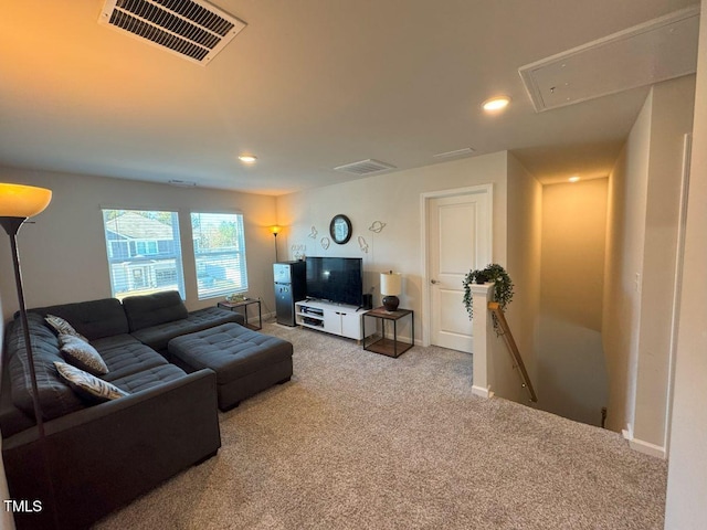 carpeted living room featuring recessed lighting, visible vents, baseboards, and attic access