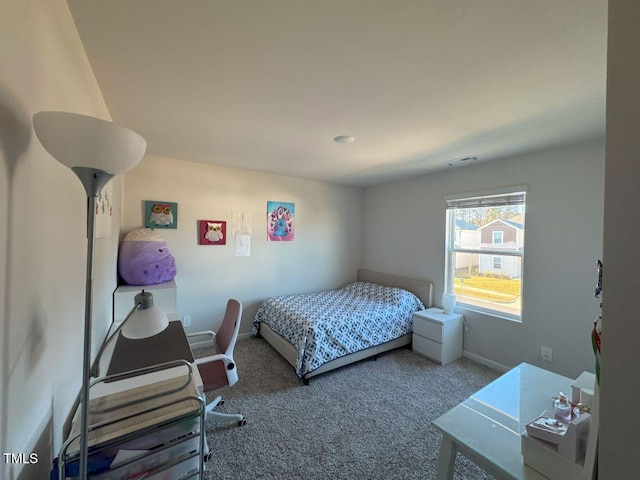 carpeted bedroom featuring visible vents and baseboards