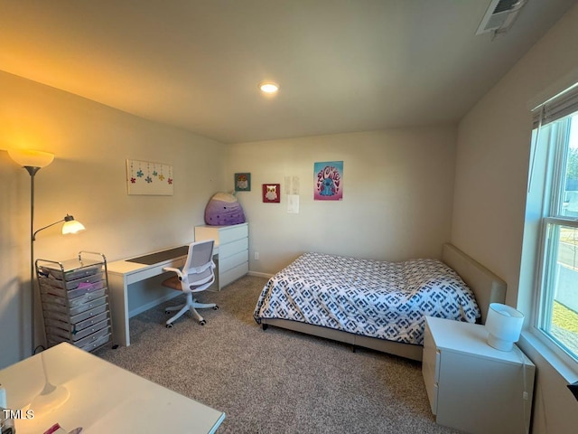 bedroom with visible vents, carpet floors, and baseboards