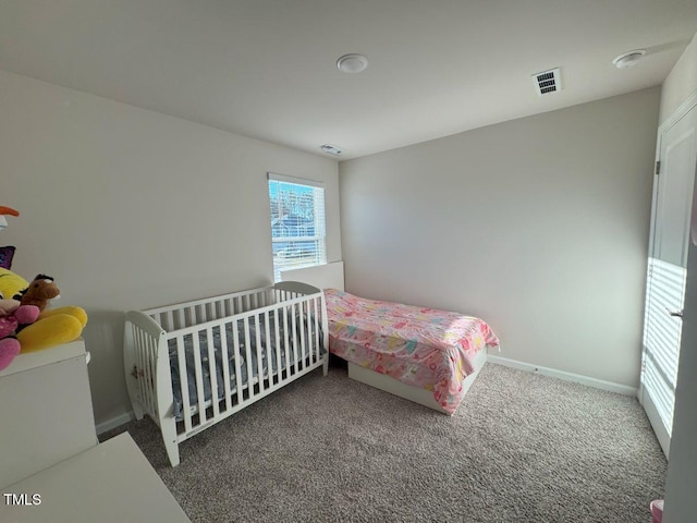 carpeted bedroom with visible vents and baseboards