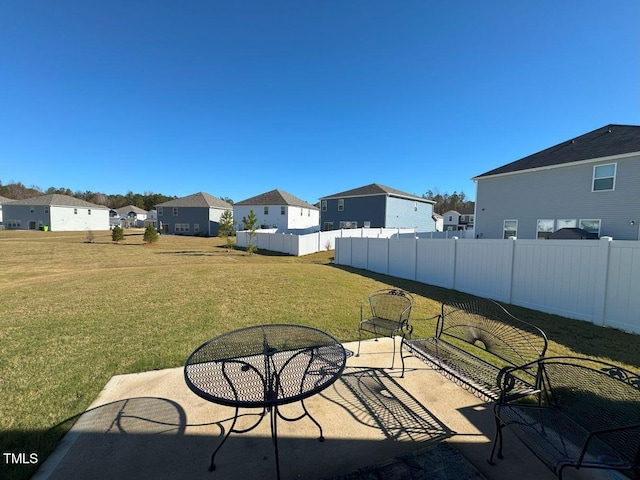 view of patio / terrace with fence and a residential view