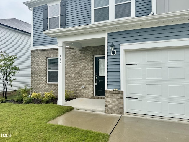 768 Riguard Way, Wendell, NC 27591 - doorway to property featuring brick siding, a yard, and a garage