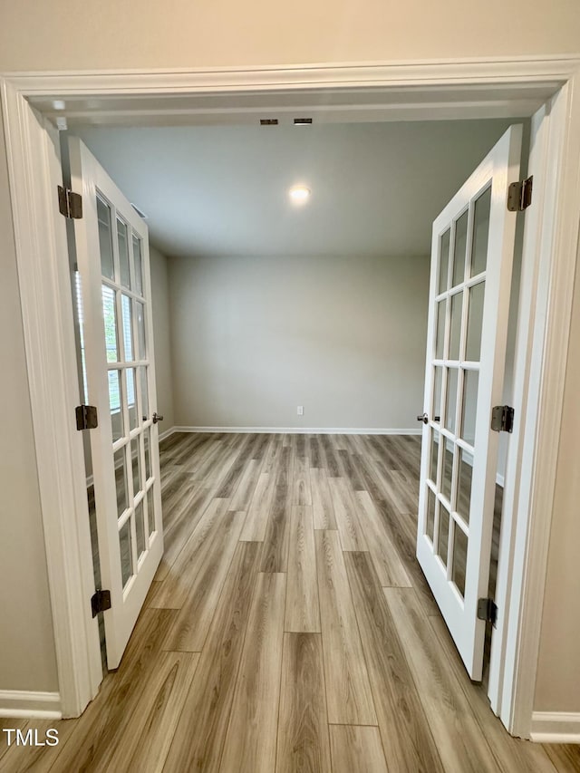 768 Riguard Way, Wendell, NC 27591 - unfurnished room featuring french doors, wood finished floors, and baseboards