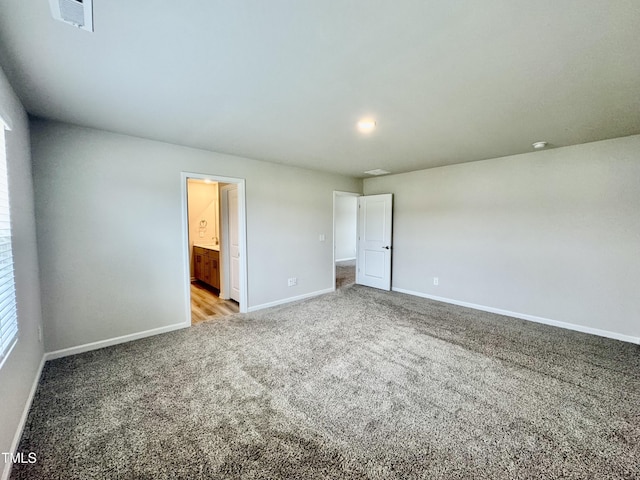 768 Riguard Way, Wendell, NC 27591 - unfurnished bedroom with carpet, baseboards, and connected bathroom