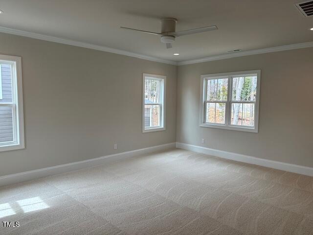 unfurnished room featuring light carpet, visible vents, crown molding, and a ceiling fan