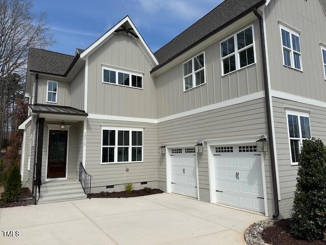 view of front of home with board and batten siding, concrete driveway, an attached garage, a shingled roof, and crawl space