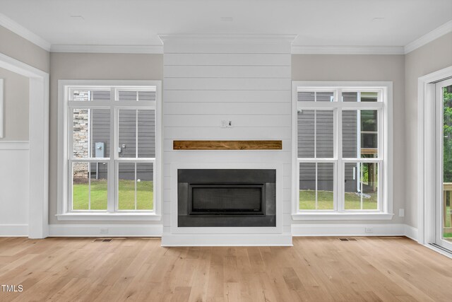 12912 Grey Willow Dr, Raleigh, NC 27613 - unfurnished living room with wood finished floors, ornamental molding, a fireplace, and baseboards