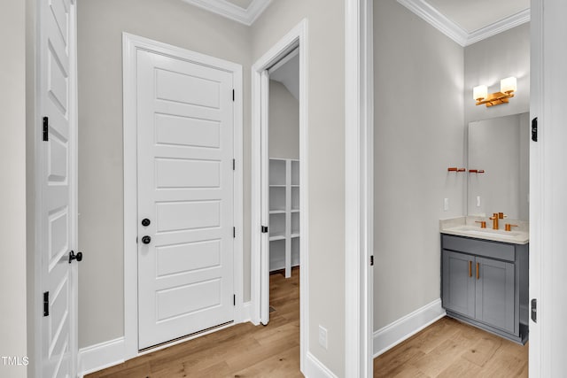 12912 Grey Willow Dr, Raleigh, NC 27613 - hall featuring ornamental molding, a sink, light wood-type flooring, and baseboards