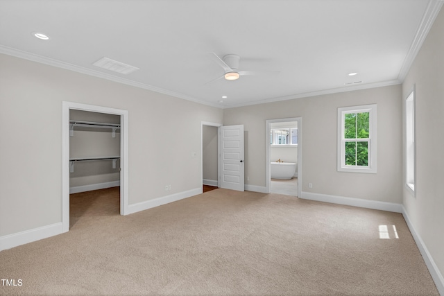 12912 Grey Willow Dr, Raleigh, NC 27613 - unfurnished bedroom featuring crown molding, carpet floors, a walk in closet, baseboards, and connected bathroom