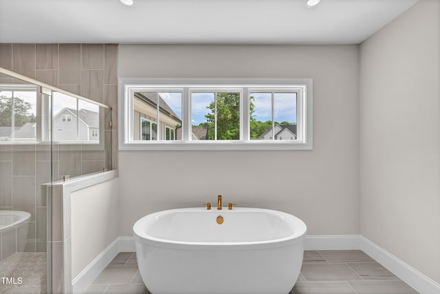 12912 Grey Willow Dr, Raleigh, NC 27613 - bathroom with a soaking tub, a stall shower, baseboards, tile patterned flooring, and recessed lighting