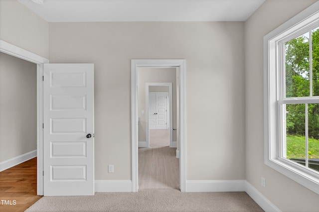 12912 Grey Willow Dr, Raleigh, NC 27613 - unfurnished bedroom featuring multiple windows, baseboards, and carpet flooring