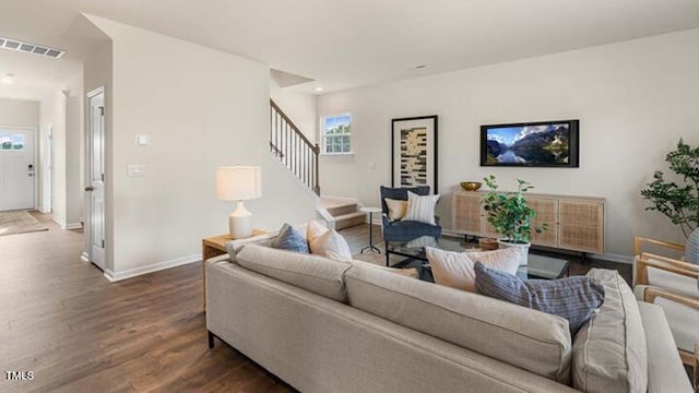 living area featuring wood finished floors, visible vents, baseboards, recessed lighting, and stairs