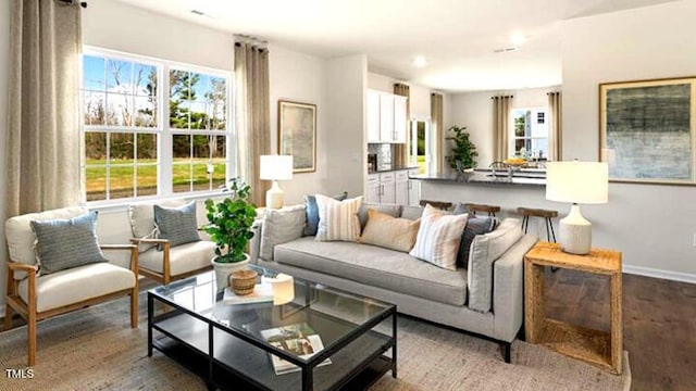 living room with baseboards and light wood-style floors