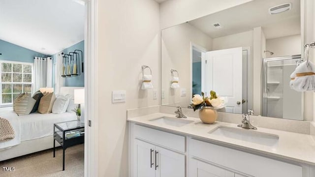 full bath featuring a sink, connected bathroom, a stall shower, and double vanity