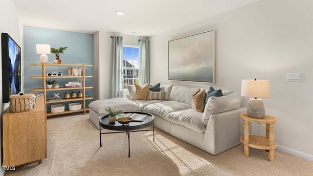 carpeted living room featuring baseboards