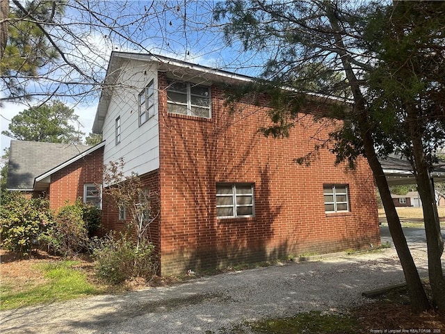 view of side of property with brick siding