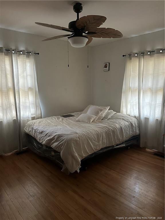 bedroom with dark wood finished floors and ceiling fan