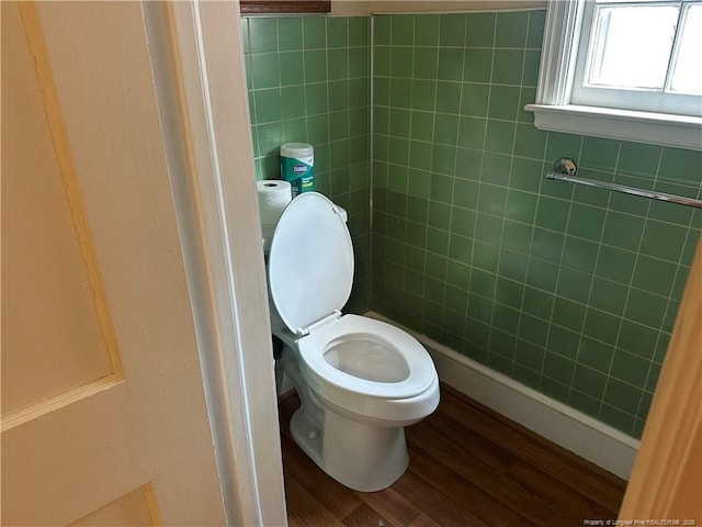 bathroom featuring toilet, tile walls, and wood finished floors