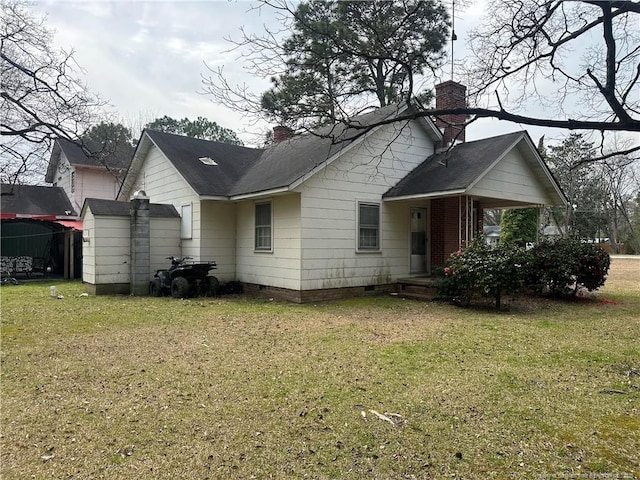 rear view of house with crawl space, a lawn, roof with shingles, and a chimney