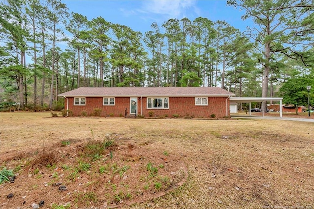 ranch-style house with brick siding, an attached carport, and a front lawn