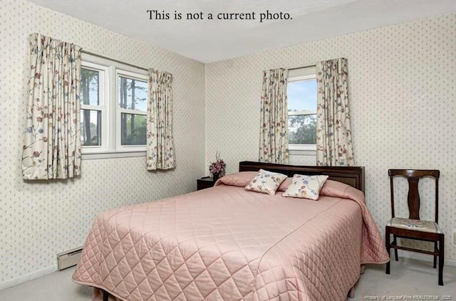 bedroom featuring wallpapered walls, carpet flooring, baseboards, and a baseboard radiator