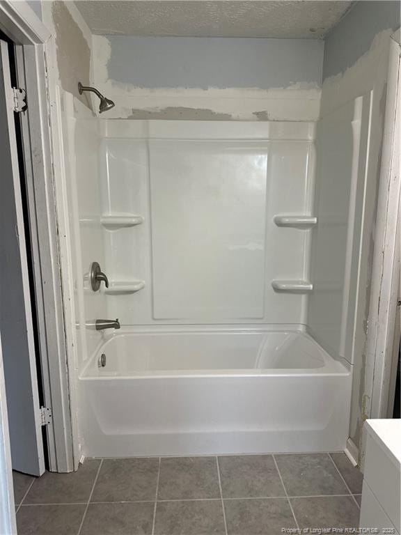 full bathroom with tile patterned floors, shower / washtub combination, a textured ceiling, and vanity