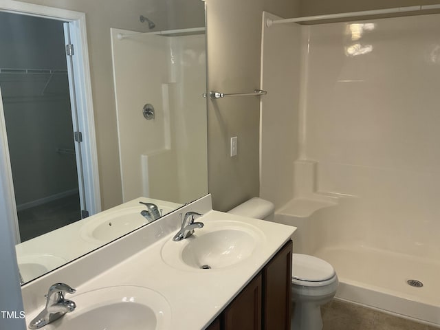 full bath with a shower stall and a sink