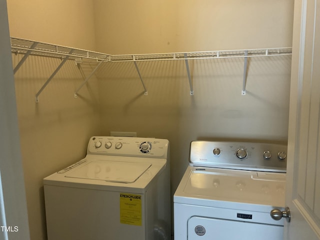 clothes washing area with washer and dryer and laundry area