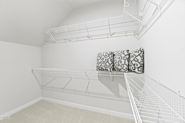 spacious closet with carpet floors and lofted ceiling