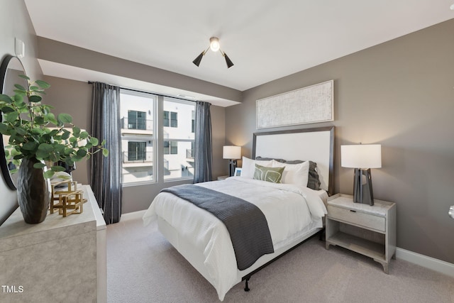 carpeted bedroom featuring baseboards and ceiling fan